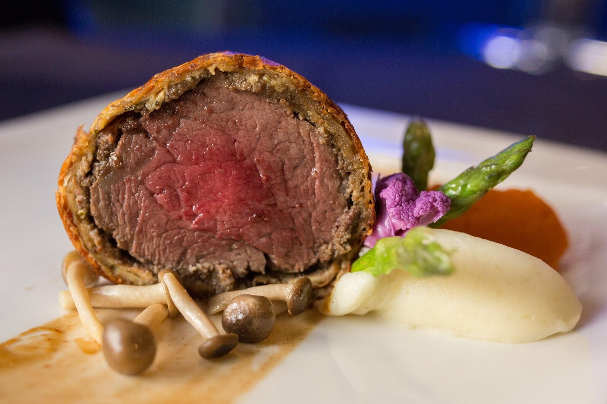 Signature dish by Chef Paul Syms highlighting culinary excellence and visual appeal